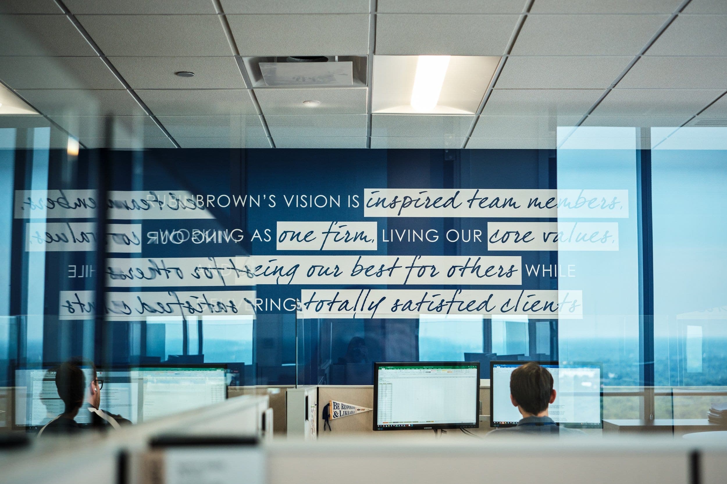RubinBrown reception lounge at the Centene Building in Clayton with branded culture wall, lifestyle frame the kind that anchors a careers page