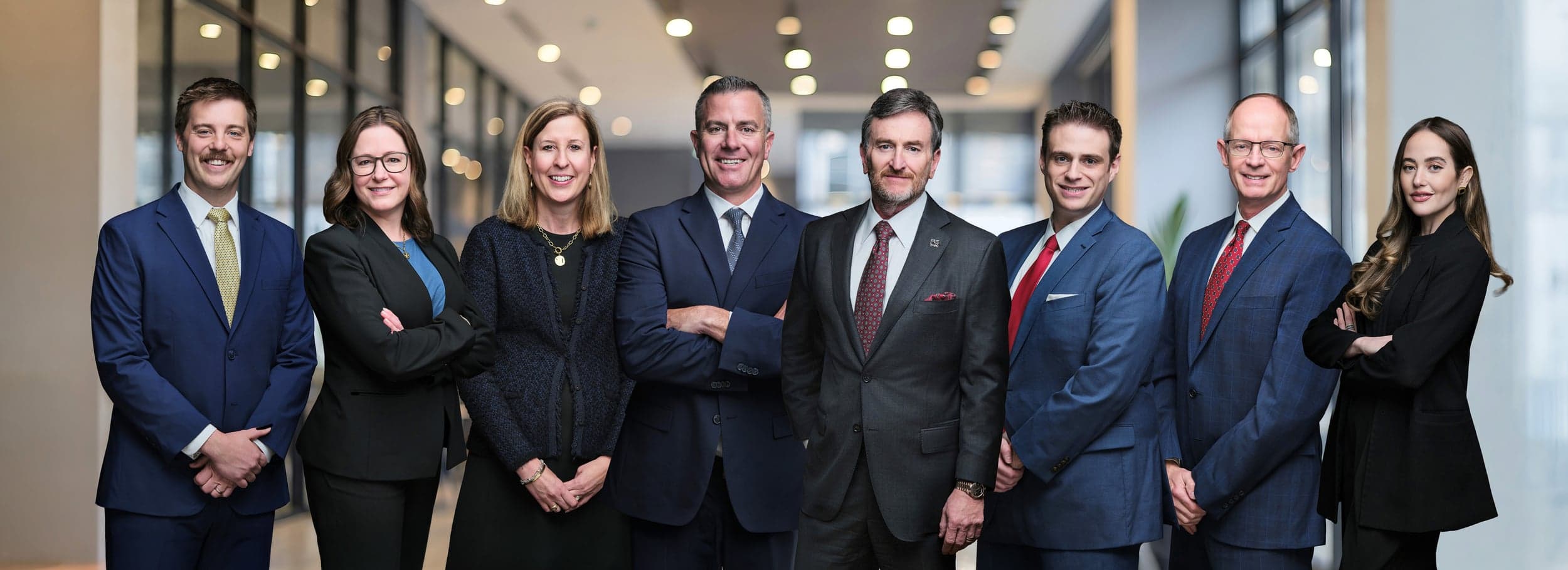 The Taxman & Landy Team at Merrill Lynch with Alan Taxman in the foreground, eight wealth management professionals composited into one cohesive group portrait by Henry David Photography