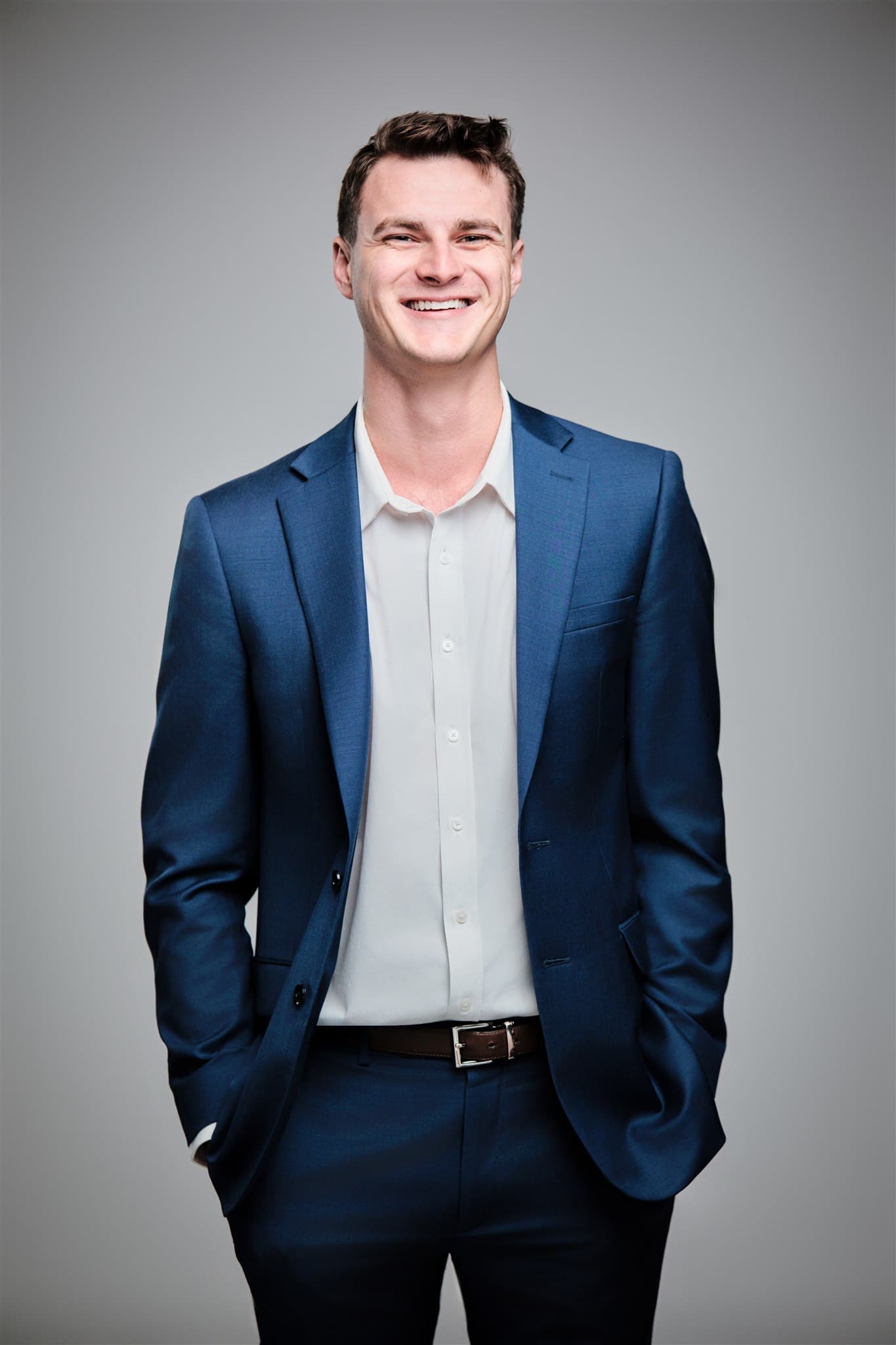 Corporate headshot of Noah Wagner in navy suit by Henry David Photography
