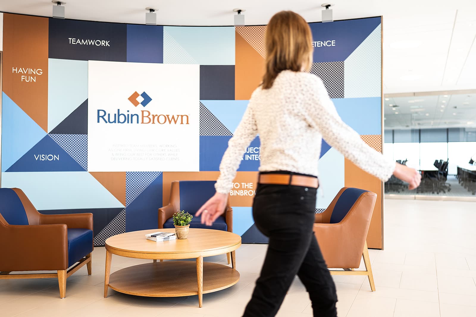 RubinBrown branded culture wall in office lobby with company values vinyl-applied across glass, photographed in Clayton